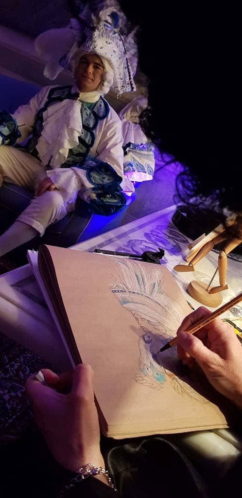 The live painter draws a costumed guest during a private event in Venice, Italy.